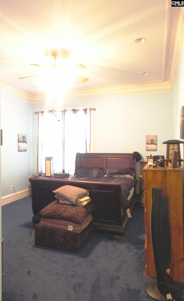 bedroom featuring dark colored carpet, ceiling fan, and ornamental molding