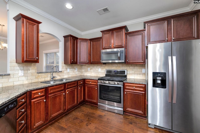 kitchen with sink, dark hardwood / wood-style floors, decorative backsplash, ornamental molding, and appliances with stainless steel finishes