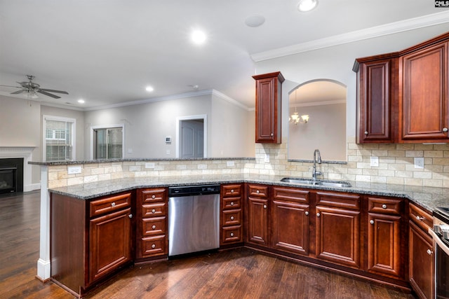 kitchen with sink, dark hardwood / wood-style floors, ornamental molding, kitchen peninsula, and stainless steel appliances