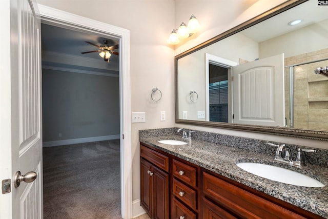 bathroom with vanity, crown molding, ceiling fan, and a shower with shower door