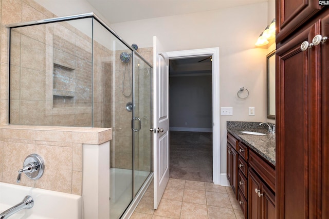 bathroom featuring tile patterned flooring, vanity, and separate shower and tub