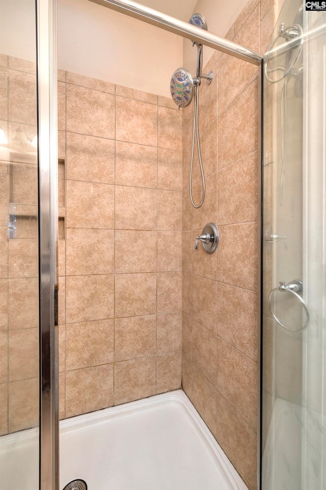 bathroom with tiled shower