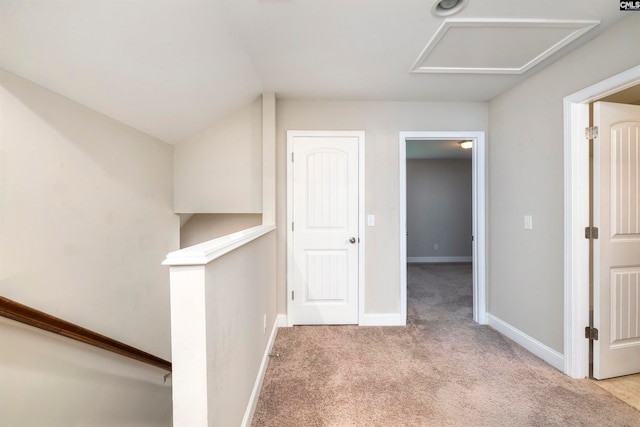 hall with light colored carpet and lofted ceiling