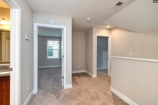 corridor with light colored carpet