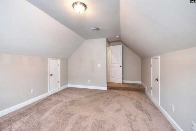 bonus room with light carpet and lofted ceiling