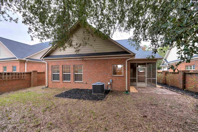 back of house featuring a sunroom and central air condition unit