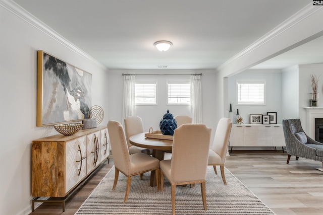 dining room featuring crown molding and hardwood / wood-style flooring