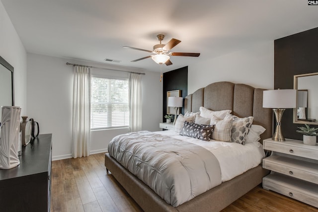 bedroom featuring hardwood / wood-style floors and ceiling fan