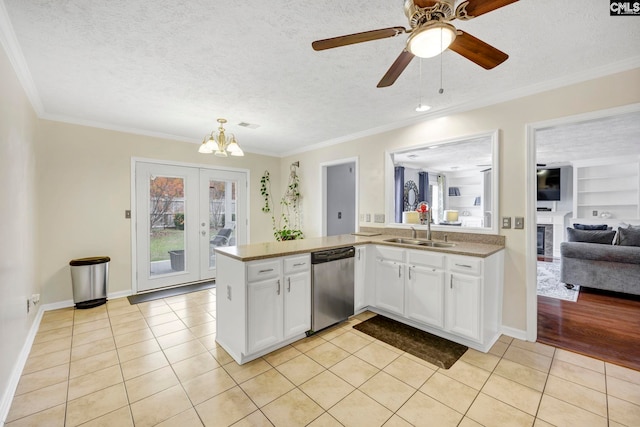 kitchen with stainless steel dishwasher, white cabinetry, a textured ceiling, and light tile patterned floors