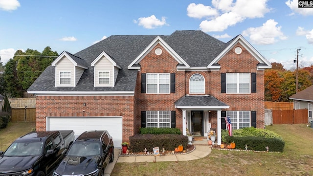 view of front of home with a front lawn and a garage