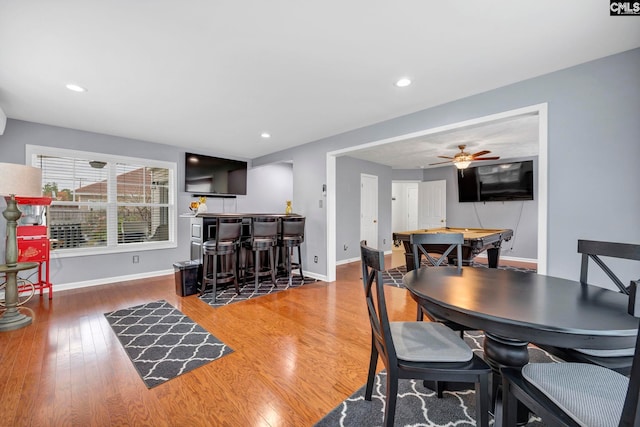 dining room featuring hardwood / wood-style flooring, ceiling fan, billiards, and indoor bar