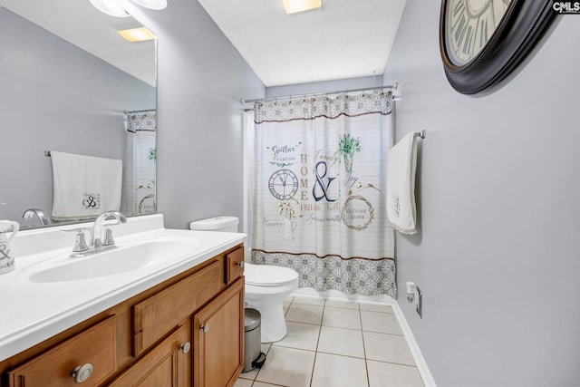 bathroom with tile patterned flooring, vanity, toilet, and vaulted ceiling