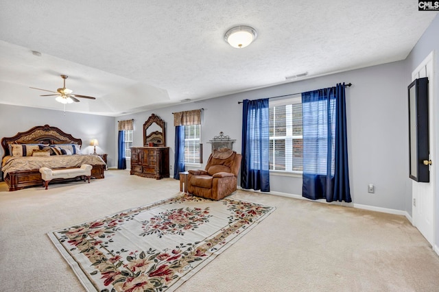 carpeted bedroom with ceiling fan and a textured ceiling