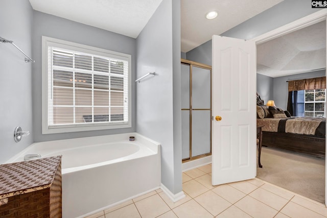 bathroom featuring a textured ceiling, tile patterned floors, and independent shower and bath