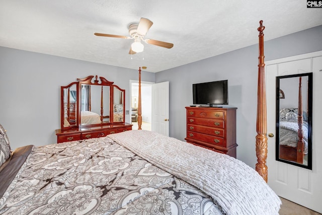 carpeted bedroom with a textured ceiling and ceiling fan