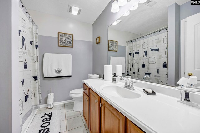 bathroom featuring a shower with curtain, vanity, a textured ceiling, tile patterned flooring, and toilet