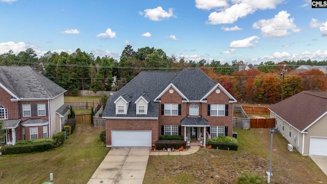 view of front of property featuring covered porch, a garage, and a front lawn