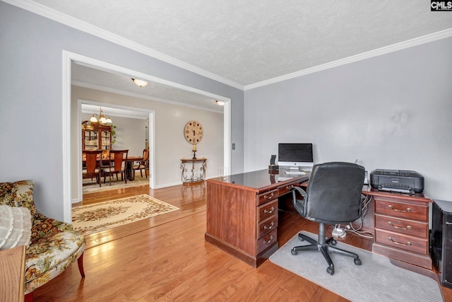 home office with ornamental molding, light hardwood / wood-style floors, a textured ceiling, and a notable chandelier