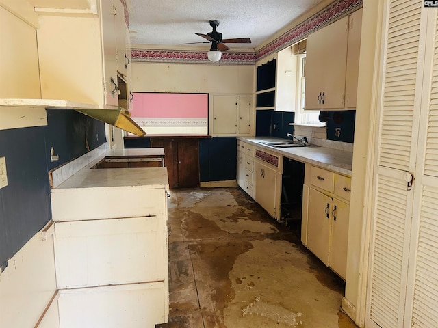 kitchen with cream cabinets, sink, ceiling fan, black electric cooktop, and a textured ceiling