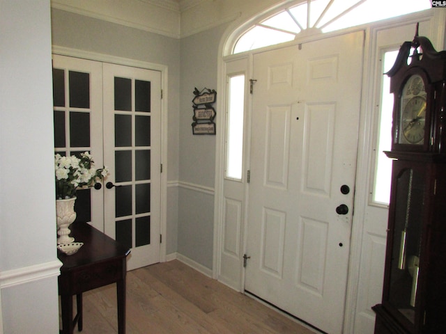 foyer featuring hardwood / wood-style floors, french doors, and a healthy amount of sunlight