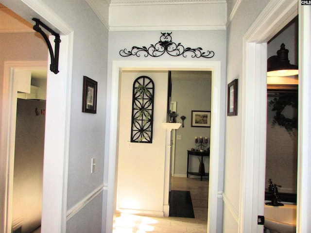 hallway featuring sink and crown molding