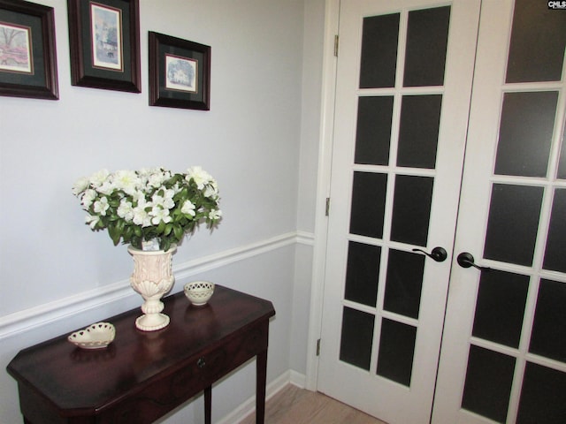 entryway featuring hardwood / wood-style floors and french doors