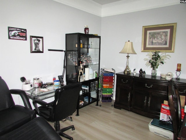 home office featuring ornamental molding and light hardwood / wood-style flooring