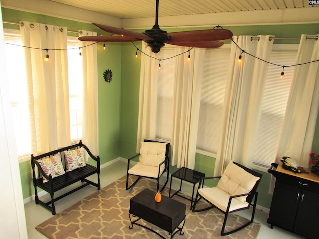 living area featuring ceiling fan and wooden ceiling