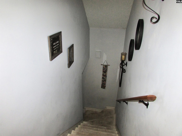 stairs with hardwood / wood-style floors and vaulted ceiling