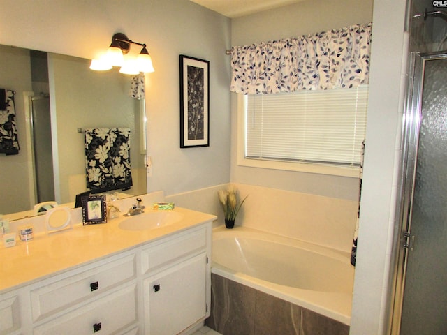 bathroom featuring separate shower and tub and vanity