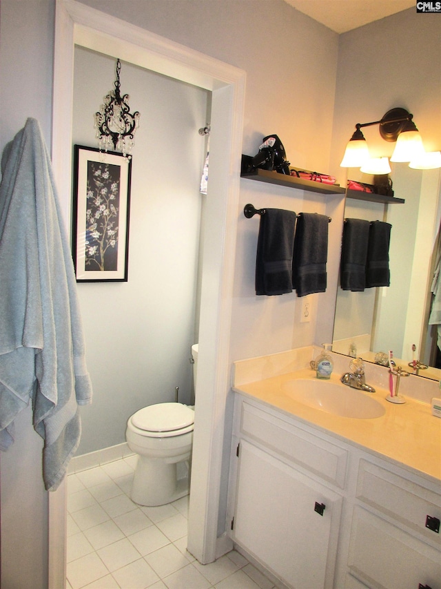 bathroom with tile patterned flooring, vanity, and toilet