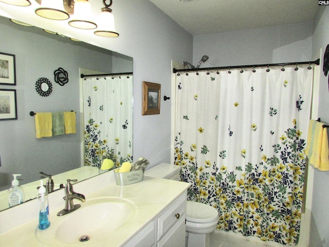 bathroom featuring vanity, curtained shower, and toilet