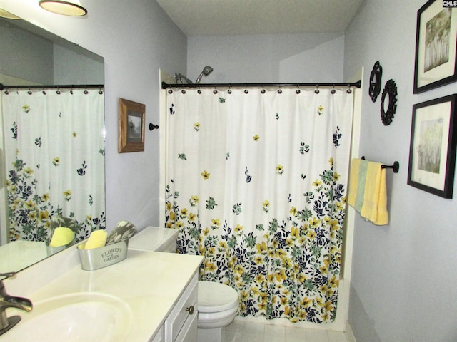 bathroom featuring tile patterned floors, vanity, a shower with shower curtain, and toilet