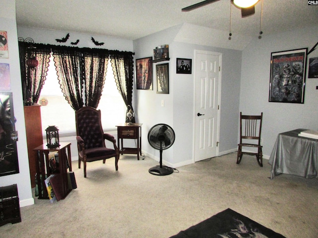 sitting room featuring a textured ceiling, carpet floors, vaulted ceiling, and ceiling fan