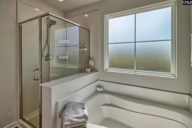 bathroom with shower with separate bathtub