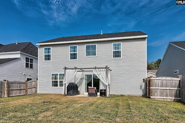 rear view of house with a yard, a pergola, and a patio