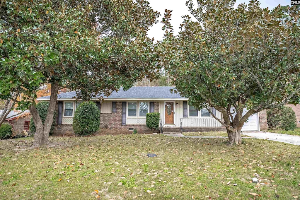 view of front of property with a front lawn and a garage