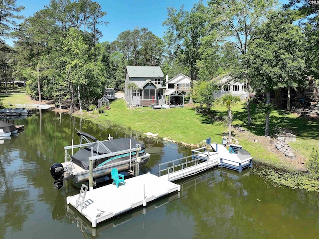 dock area with a yard and a water view