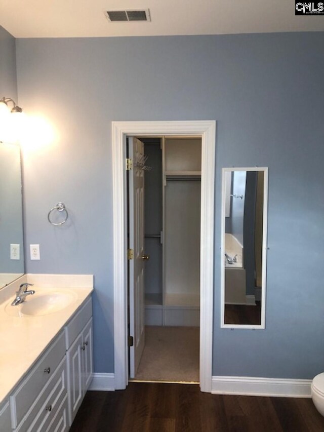 346 Arbor Oaks Ln, Irmo, SC 29063 - bathroom with wood finished floors, double vanity, baseboards, and toilet
