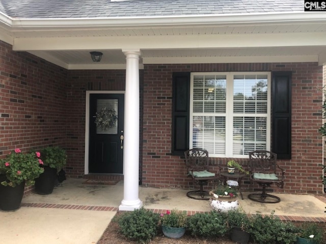 doorway to property featuring covered porch