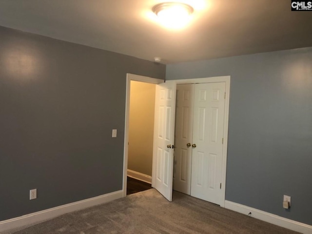 unfurnished bedroom featuring carpet floors and a closet