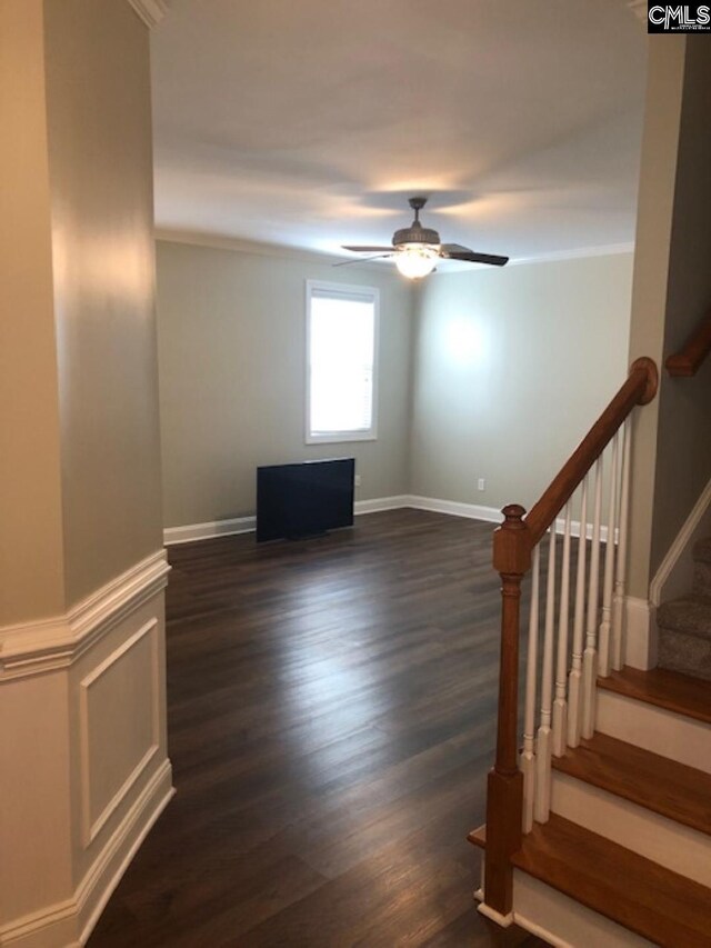 346 Arbor Oaks Ln, Irmo, SC 29063 - unfurnished living room featuring ceiling fan, dark wood-style flooring, stairs, ornamental molding, and baseboards