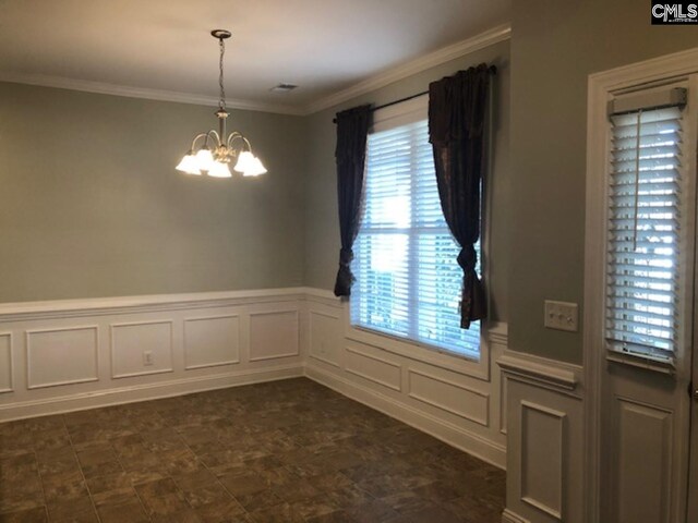 346 Arbor Oaks Ln, Irmo, SC 29063 - unfurnished dining area featuring a chandelier, a wainscoted wall, ornamental molding, and a decorative wall
