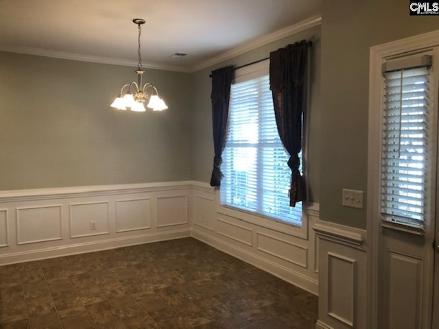 unfurnished dining area with a notable chandelier and ornamental molding