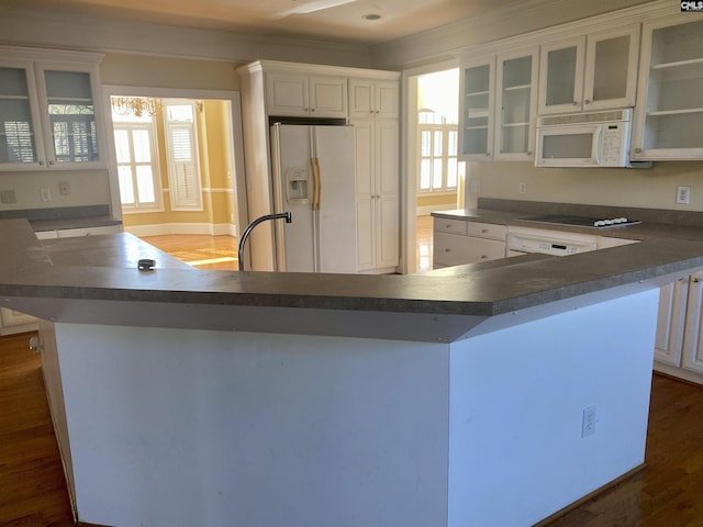 105 Overbranch Dr, Columbia, SC 29223 - kitchen featuring white appliances, dark countertops, dark wood-type flooring, white cabinets, and glass insert cabinets