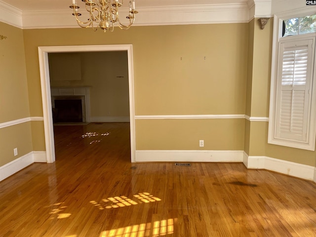 105 Overbranch Dr, Columbia, SC 29223 - unfurnished room featuring a chandelier, ornamental molding, wood finished floors, a fireplace, and baseboards