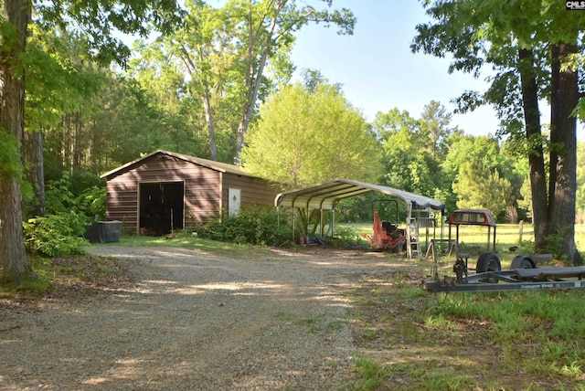 exterior space featuring a carport and an outbuilding