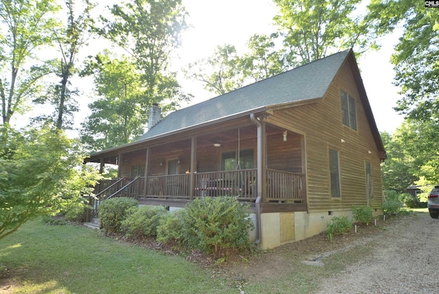 view of side of property with a porch