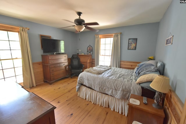 bedroom with ceiling fan and light wood-type flooring