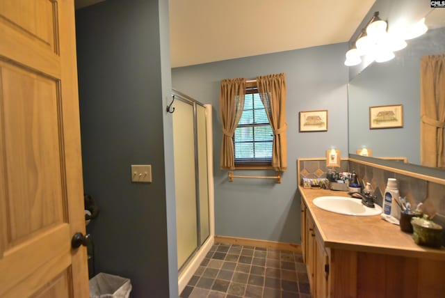 bathroom featuring vanity and an enclosed shower